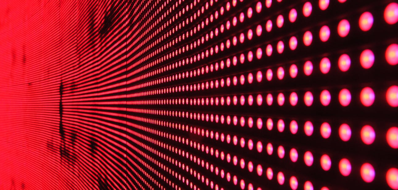 Vibrant abstract pattern of illuminated red LED lights forming a dynamic design.